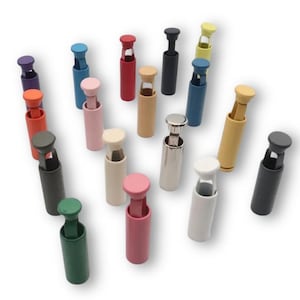 May include: Assortment of colorful plastic bottle stoppers in various colors, including red, blue, green, yellow, pink, and black. The stoppers are designed to fit standard wine bottles.
