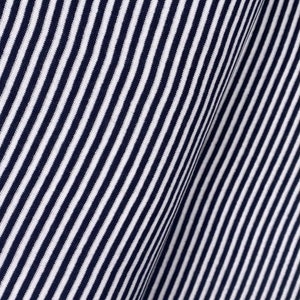 May include: Close-up of a white and navy blue striped fabric. The fabric has a diagonal pattern and a soft, textured feel.