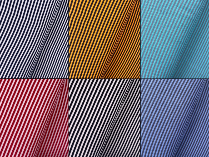 May include: A collection of six fabric swatches with diagonal stripes in various colors, including navy blue, yellow, turquoise, red, black, and blue.