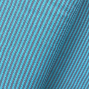 May include: Close-up of a blue and gray striped fabric. The fabric has a diagonal pattern and a soft, textured feel.