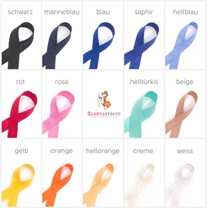 Pode incluir: Uma coleção de 12 amostras de fita em várias cores, incluindo preto, azul marinho, azul, safira, azul claro, vermelho, rosa, turquesa, bege, amarelo, laranja, pêssego, creme e branco. As fitas estão dispostas em uma grade com os nomes das cores escritos acima de cada fita.
