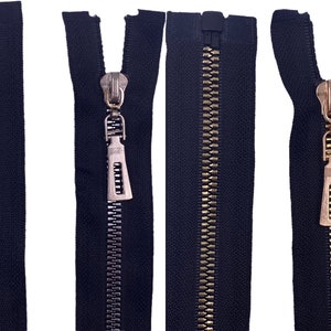 May include: Four black zipper closures with metal teeth. The zippers have different colored pulls: silver, gold, and rose gold.
