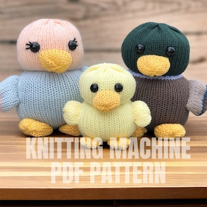 May include: Knitting machine PDF pattern for three knitted animal toys: a light blue duck, a yellow duckling, and a brown and green duck.
