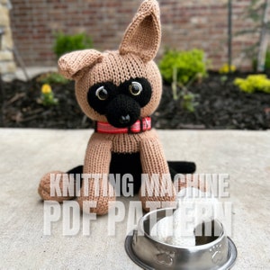 May include: Knitted brown and black dog toy with large black eyes. The dog is sitting in front of a metal dog bowl with a white bone inside. The text "KNITTING MACHINE PDF PATTERN" is visible in the image.