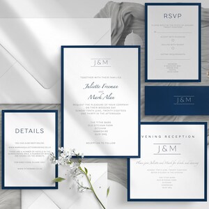 May include: A collection of elegant wedding stationery featuring a navy blue and white color scheme. The set includes invitations, RSVP cards, details cards, and envelopes. The invitations display the names "Juliette Freeman and Mark Alan".