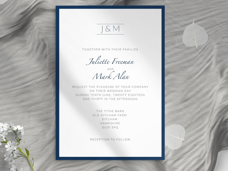 May include: A formal wedding invitation with a navy blue border. The invitation features the names "Juliette Freeman" and "Mark Alan" in elegant script. The text includes the wedding date, time, and location: The Tithe Barn, Ditcham, Hampshire.