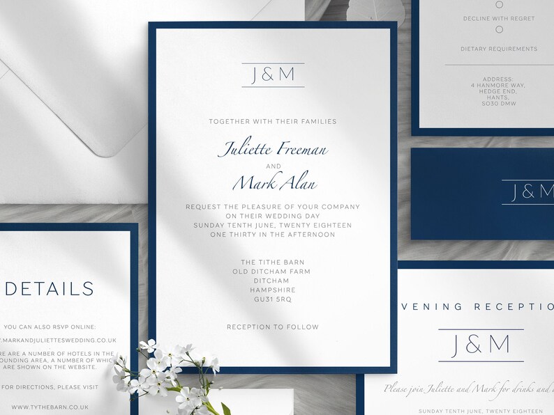 May include: Elegant navy blue and white wedding invitation suite. The main invitation features the names "Juliette Freeman and Mark Alan" with event details. Additional cards include RSVP, details, and reception information. The suite is accented with a navy blue border.