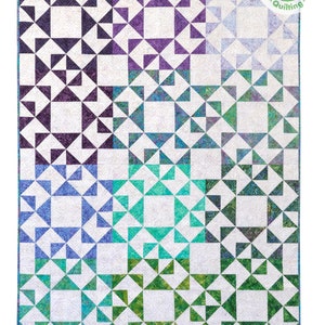 May include: A quilt with a geometric pattern of white squares with a border of triangles in shades of purple, blue, green, and teal.