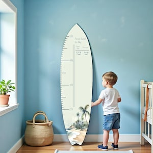 May include: A surfboard-shaped growth chart with a beach scene at the bottom. The chart measures up to 5 feet and has space to record dates and notes. A young child stands next to the chart.