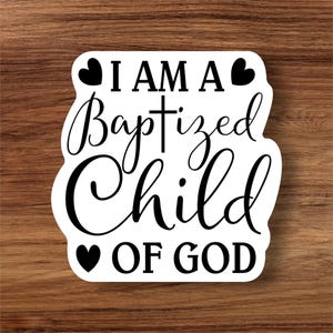 May include: White sticker with black text and hearts that reads "I am a Baptized Child of God" with a cross symbol between "Baptized" and "Child".