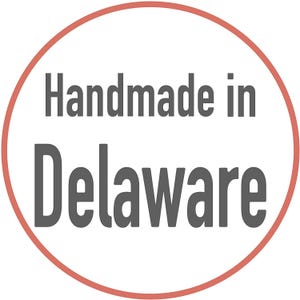 May include: A red circle with a white background and the text "Handmade in Delaware" in gray.