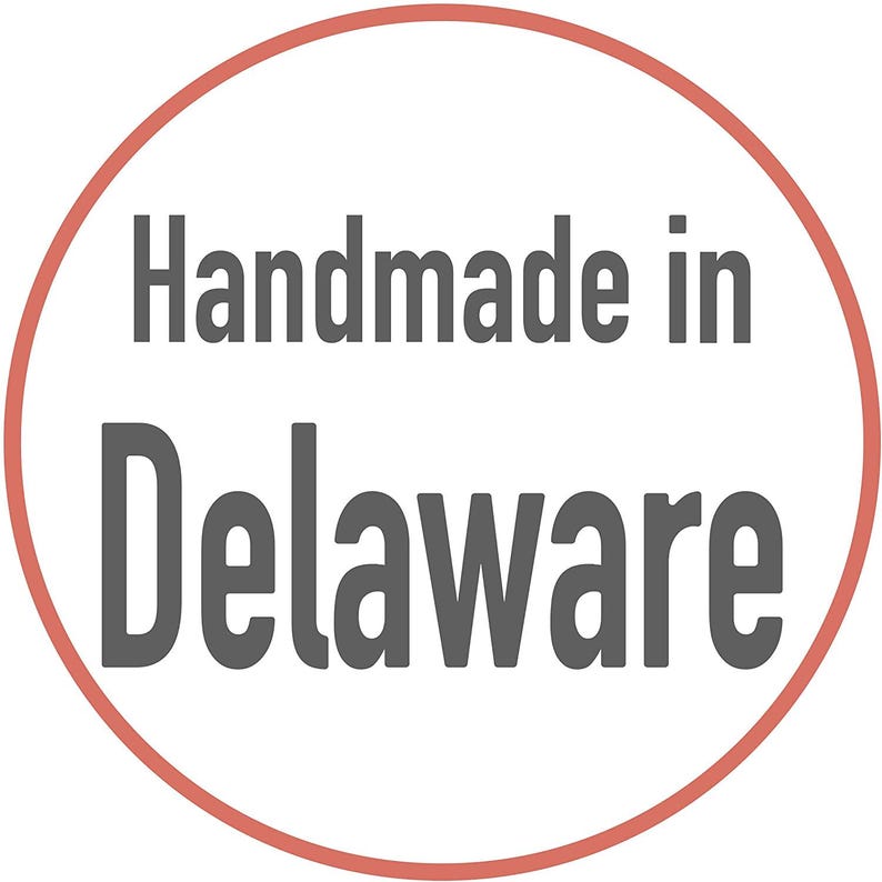 May include: A red circle with a white background and the text "Handmade in Delaware" in gray.