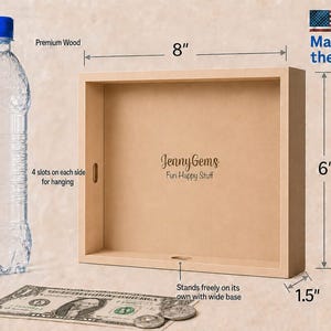 A wooden hanging display box labeled 'JennyGems Fun Happy Stuff' shown with dimension callouts: 8 inches wide, 6 inches tall, and 1.5 inches deep.