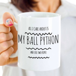 May include: White ceramic mug with black text that reads "All I care about is my ball python and like two people".