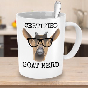 May include: White ceramic coffee mug with a black and brown goat wearing glasses and the text "CERTIFIED GOAT NERD".