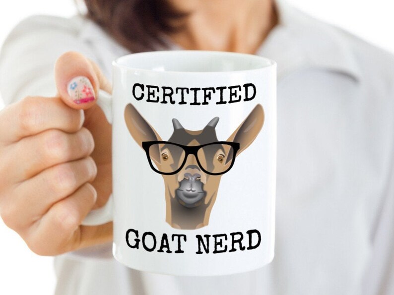 May include: White ceramic mug with a black and brown goat wearing glasses and the text "CERTIFIED GOAT NERD".