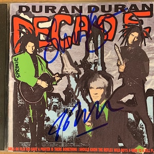 Duran Duran Decade CD Hand Signed Autographed by Simon LeBon & Nick Rhodes in Blue Ink W/ LOA