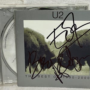 U2 The Best of 1990-2000 CD 3x Hand-Signed Autograph by Bono, The Edge and Adam Clayton In Black Sharpie w/ LOA