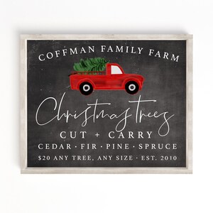 May include: A chalkboard sign with a red pickup truck carrying a Christmas tree. The sign reads "Coffman Family Farm Christmas Trees Cut + Carry Cedar Fir Pine Spruce $20 Any Tree, Any Size Est. 2010".