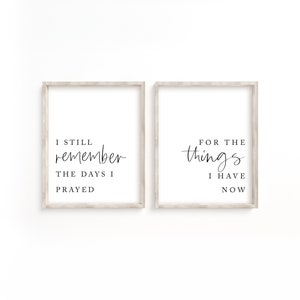 May include: Two framed prints with white backgrounds and black text. The left print says "I still remember the days I prayed." The right print says "For the things I have now."