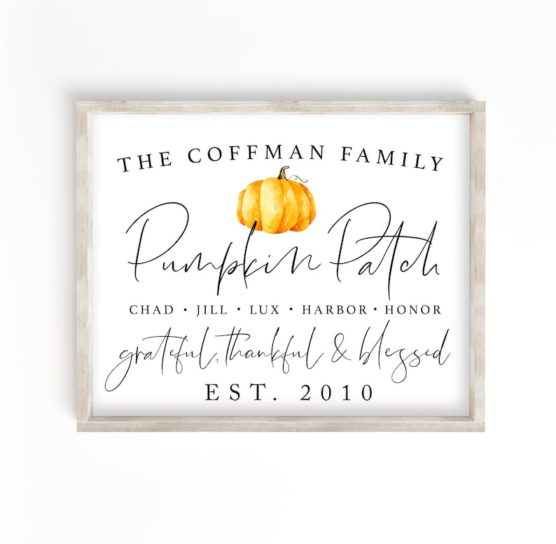May include: A white sign with a wood frame features the text "THE COFFMAN FAMILY Pumpkin Patch grateful, thankful & blessed EST. 2010" with a watercolour illustration of a pumpkin in the centre.