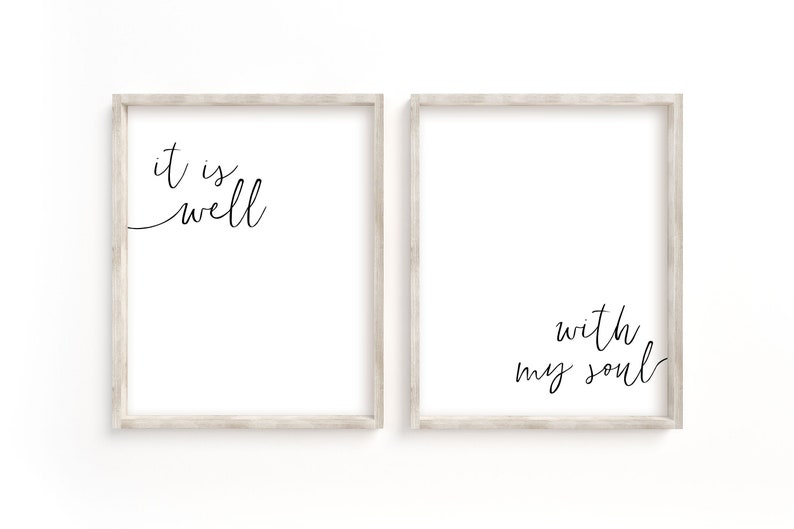 May include: Two framed prints with white backgrounds and black calligraphy. The left print says "it is well". The right print says "with my soul".