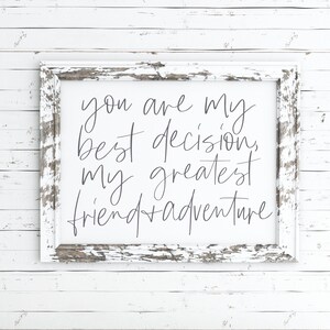May include: White distressed wood frame with a white background and the text "You are my best decision, my greatest friend + adventure" in gray script font.