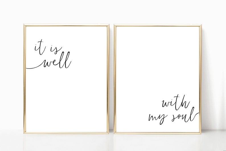 May include: Two gold framed prints with black calligraphy. The left print says "it is well". The right print says "with my soul".