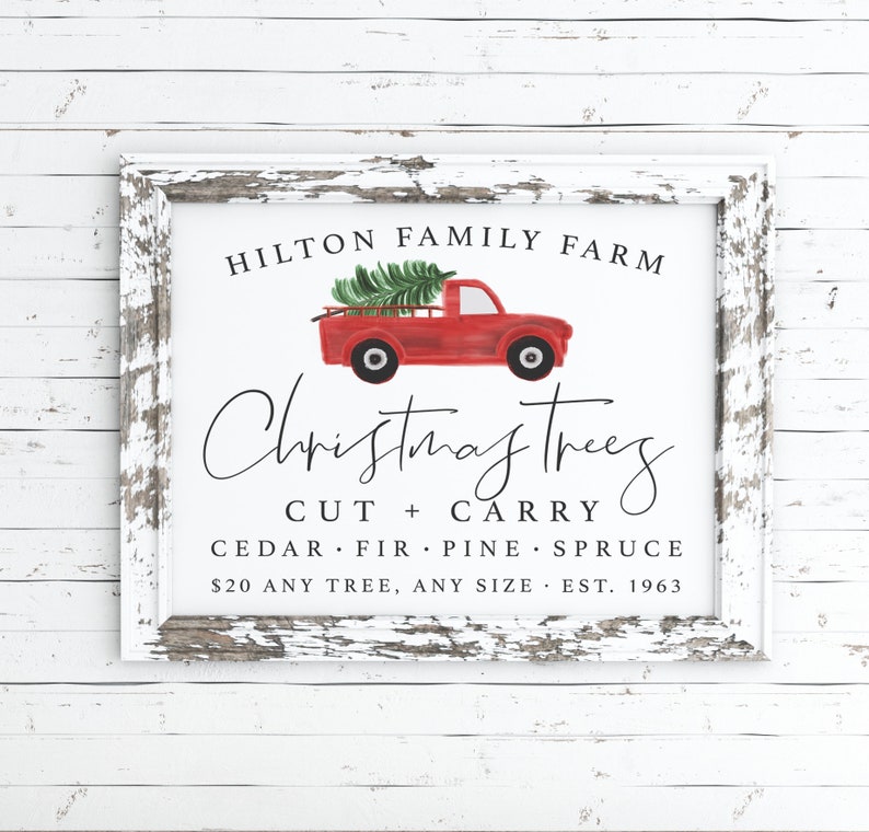 May include: A white sign with a red truck carrying a Christmas tree. The sign reads "HILTON FAMILY FARM Christmas trees CUT + CARRY CEDAR FIR PINE SPRUCE $20 ANY TREE, ANY SIZE EST. 1963"