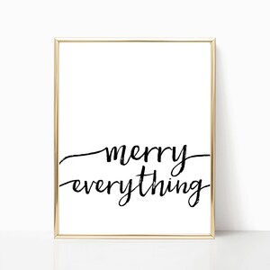May include: A white framed print with black calligraphy that reads "merry everything".