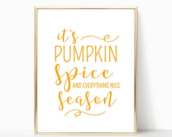 May include: A gold framed print with the text "it's pumpkin spice and everything nice season" in orange lettering.