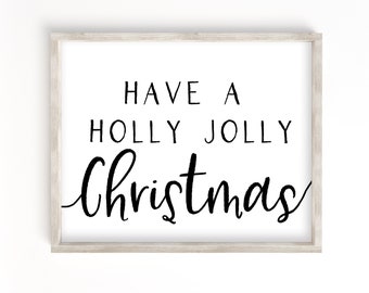 Może przedstawiać: Biały wydruk w ramie z czarnym tekstem, który brzmi "Have a Holly Jolly Christmas".