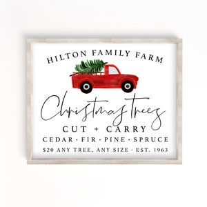 May include: A white sign with a red truck carrying a Christmas tree. The sign reads "Hilton Family Farm Christmas Trees Cut + Carry Cedar Fir Pine Spruce $20 Any Tree, Any Size Est. 1963"