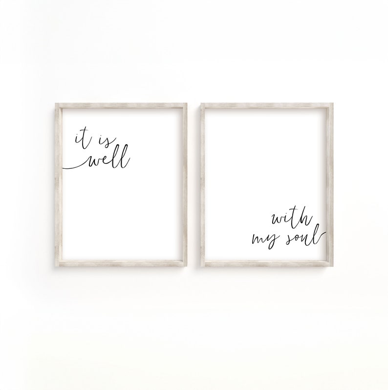 May include: Two framed prints with white backgrounds and black calligraphy. The left print says "it is well" and the right print says "with my soul".