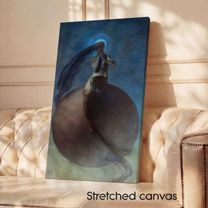 May include: Stretched canvas art print featuring a surreal illustration of a figure with long hair, set against a blue background. The figure is seated on a large, dark sphere. The text "Stretched canvas" is visible at the bottom.
