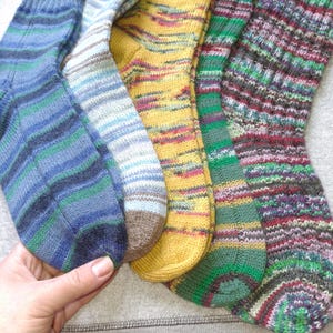 May include: Four pairs of colorful striped socks in blue, brown, yellow, and green and purple.