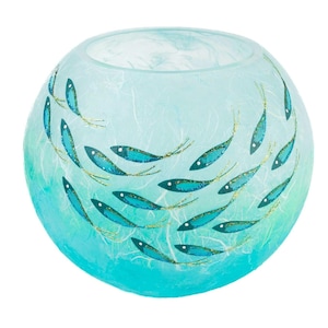 May include: A spherical glass bowl featuring a light blue and turquoise gradient background with a textured, fibrous appearance. The exterior is decorated with a school of small, dark blue fish painted with gold glitter accents and white eyes.