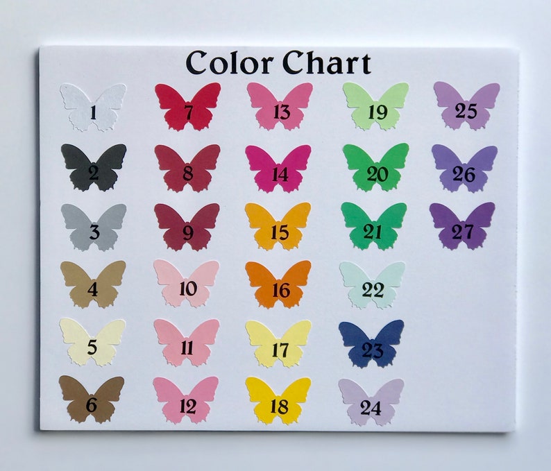 May include: A colour chart displaying 27 paper butterfly cutouts in a range of colours, arranged on a white background. The butterflies are numbered and the text "Color Chart" is visible. Colours include white, black, red, pink, and yellow.