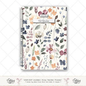 May include: A floral academic diary for the 2026/2027 academic year. The cover displays a cream background adorned with watercolor flowers in pink, purple, orange, and blue hues. The name "Mrs Macintyre" is printed on the cover. The diary is labeled "2026/2027 Academic Diary Teacher Planner".