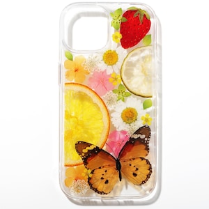 May include: A clear phone case with a pressed flower and fruit design. The case features a butterfly, orange slices, a lime wedge, a strawberry, and various white and pink flowers.