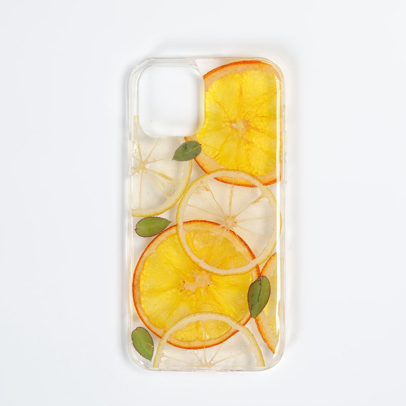Clear resin phone case with dried lemon and orange slices, leaves on it.