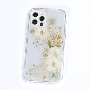 Elegant transparent phone case with natural pressed flowers on a white background, showcasing SunnyPigStudio's unique botanical design.