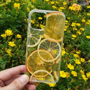 Clear resin phone case with dried lemon and orange slices, leaves on it.