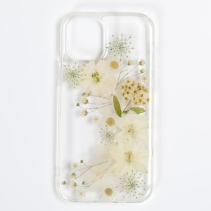 Neutral-toned clear phone case with a botanical pressed flower arrangement, reflecting SunnyPigStudio's commitment to organic aesthetics.