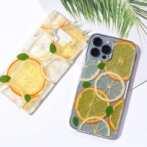 Clear resin phone case with dried lemon and orange slices, leaves on it.