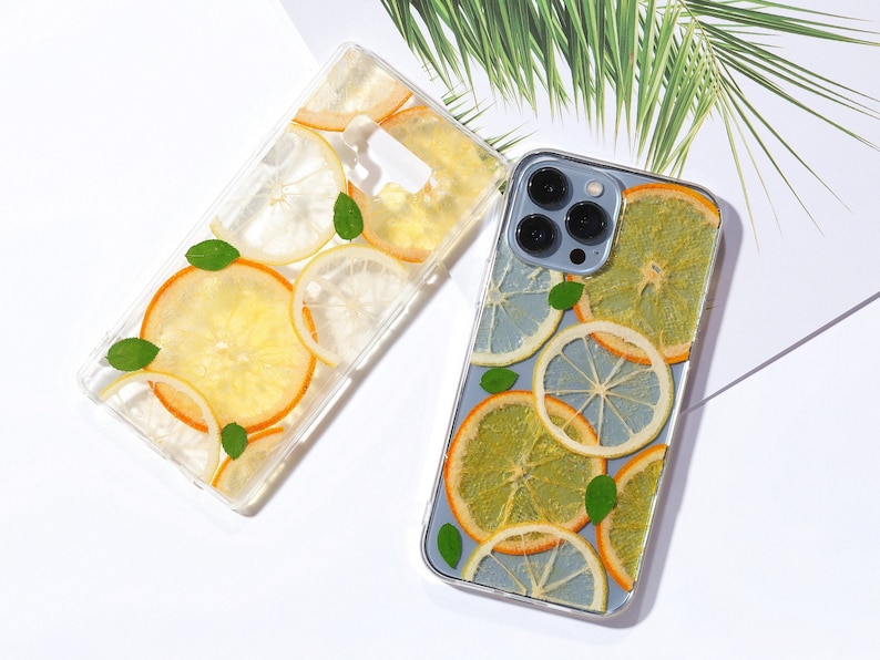 Clear resin phone case with dried lemon and orange slices, leaves on it.