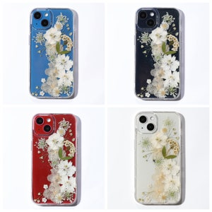 Handmade transparent phone case with a uniform floral design on varied color models, highlighting the universal appeal of SunnyPigStudio's wildflower arrangements.