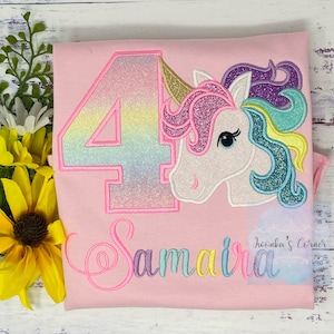 May include: Pink t-shirt with a rainbow glitter number 4, a unicorn with a rainbow mane, and the name "Samaira" embroidered in rainbow colors.