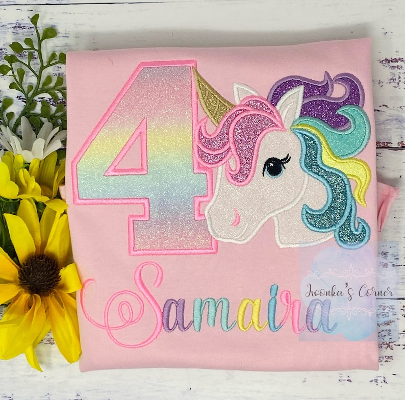 May include: Pink t-shirt with a rainbow glitter number 4, a unicorn with a rainbow mane, and the name "Samaira" embroidered in rainbow colors.