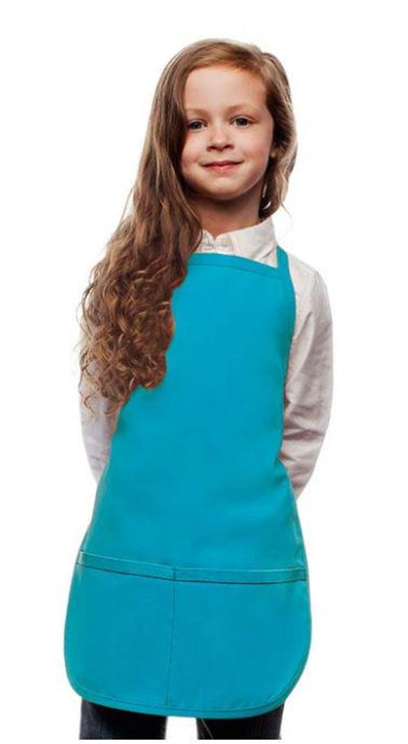 May include: A turquoise blue child-sized apron with a single pocket. The apron has adjustable straps and a curved bottom.